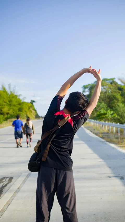 a man riding a skateboard down a sidewalk, by Rachel Reckitt, unsplash, happening, dancing on a tropical beach, with arms up, myanmar, on a bridge