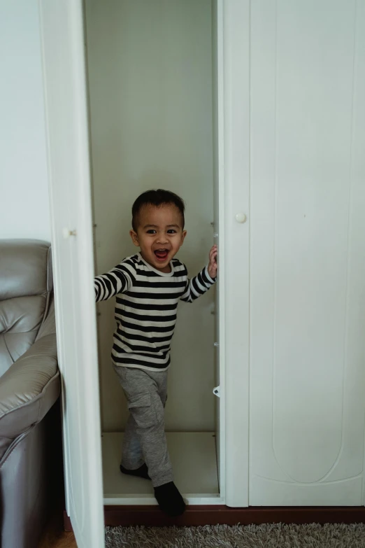 a little boy that is standing in a closet, inspired by Yu Zhiding, pexels contest winner, happening, running towards camera, playful, damien tran, riyahd cassiem