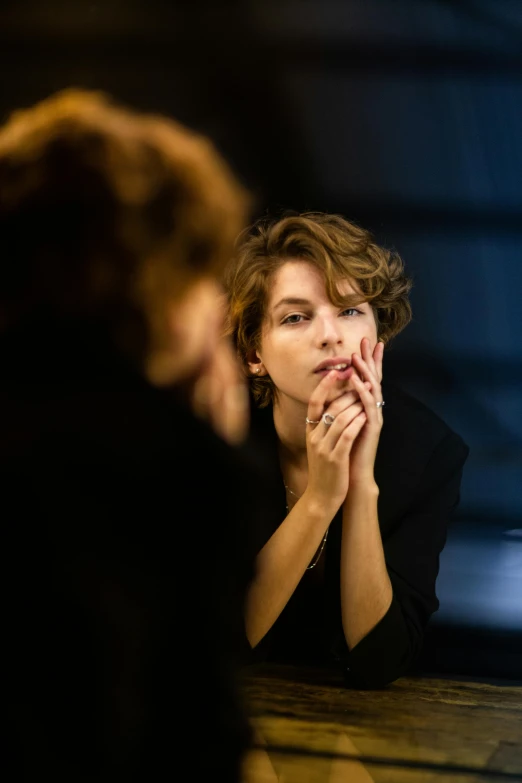 a woman looking at her reflection in a mirror, by Daniel Seghers, shutterstock, milla jovovich, medium format. soft light, fashionweek backstage, hand on her chin