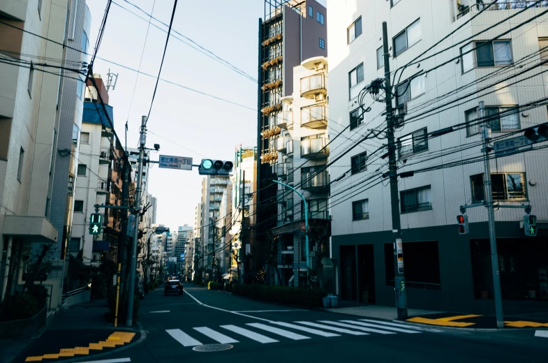 a city street filled with lots of tall buildings, unsplash, ukiyo-e, golden hour photo, empty streetscapes, rural japan, maze of streets