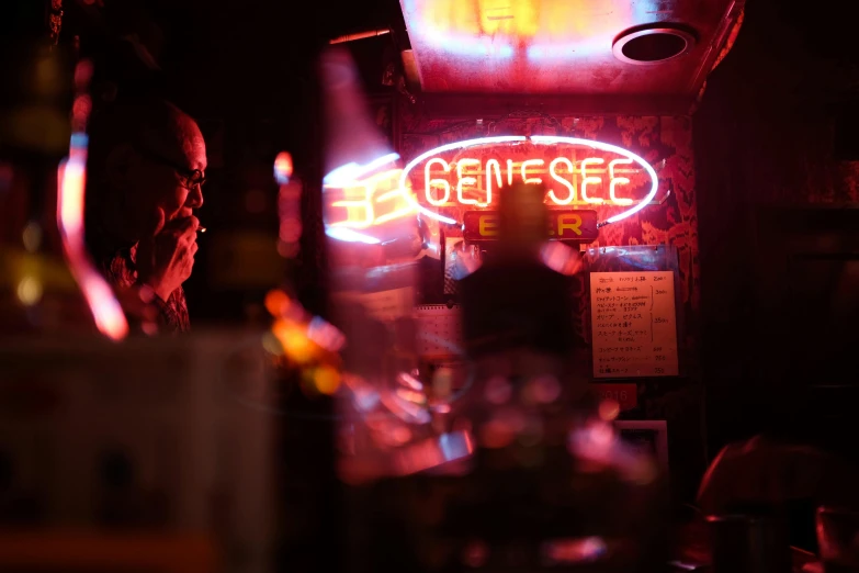 a man sitting at a bar in front of a neon sign, unsplash contest winner, mingei, intro to uncut gems, inside a tavern, sense of mystery, genesis
