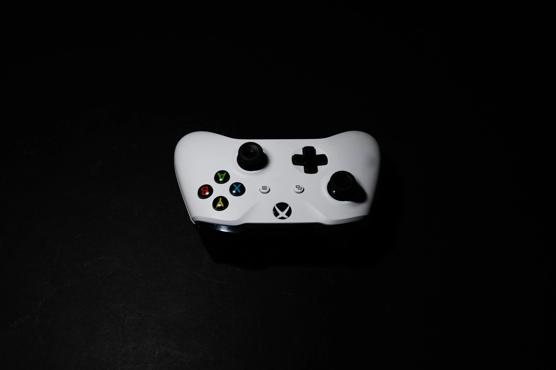 a close up of a controller on a table, by Niels Lergaard, unsplash, minimalism, white on black, xbox, portrait n - 9, cardboard