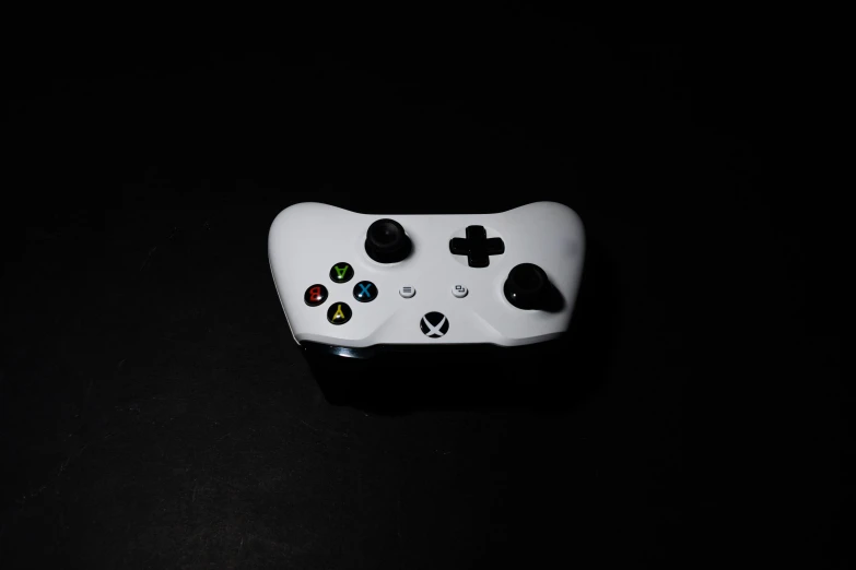 a close up of a controller on a table, by Niels Lergaard, unsplash, minimalism, white on black, xbox, portrait n - 9, cardboard