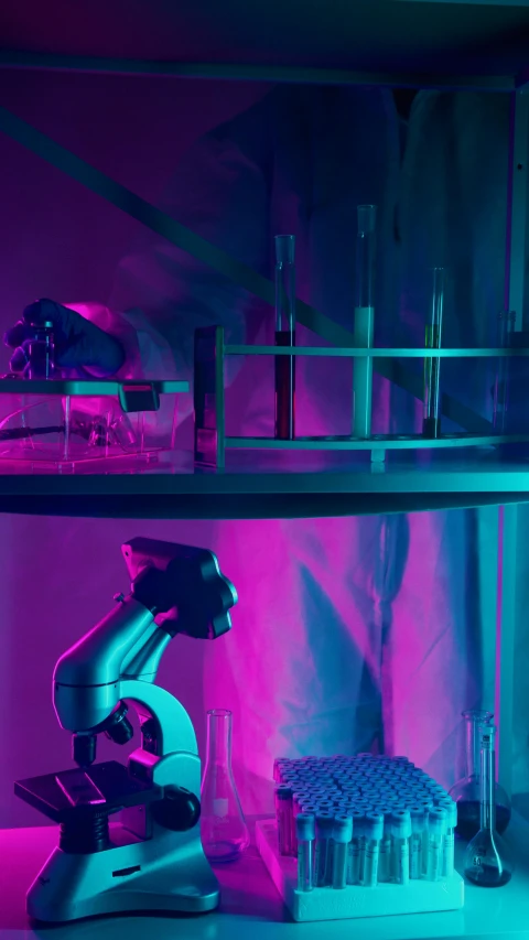 a close up of a microscope on a table, inspired by Mike Winkelmann, holography, cyan and magenta, robot barkeep, high quality photo, daniel richter