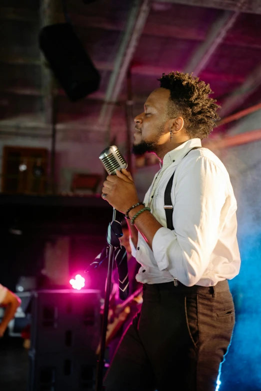 a man standing on top of a stage holding a microphone, pexels contest winner, black arts movement, in a nightclub, profile picture, thumbnail, medium shot portrait