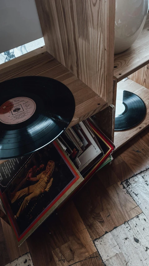 a record sitting on top of a wooden shelf, thumbnail, wooden crates, in a living room, high-quality photo