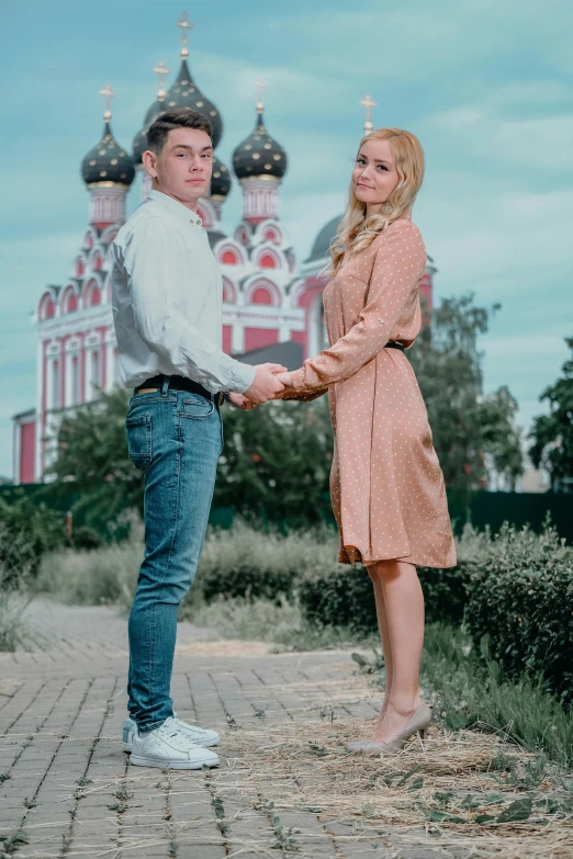 a man and a woman holding hands in front of a church, a colorized photo, by Alexander Fedosav, pexels contest winner, fashion shoot 8k, portrait photo of a backdrop, russian, gif