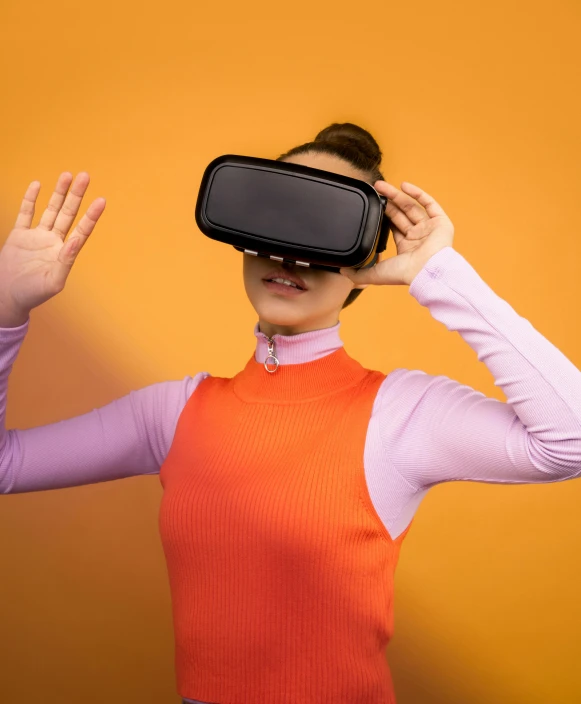 a woman wearing a virtual reality headset, trending on unsplash, hypermodernism, in front of an orange background, taken in the late 2010s, wide high angle view, holodeck