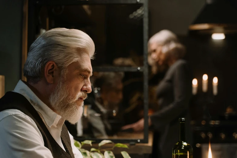 a man sitting at a table with a bottle of wine, a photorealistic painting, trending on pexels, fantastic realism, silver hair and beard, still from movie, from pacific rim, kramskoi 4 k