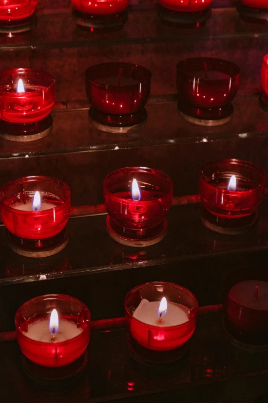 a group of red candles sitting on top of a table