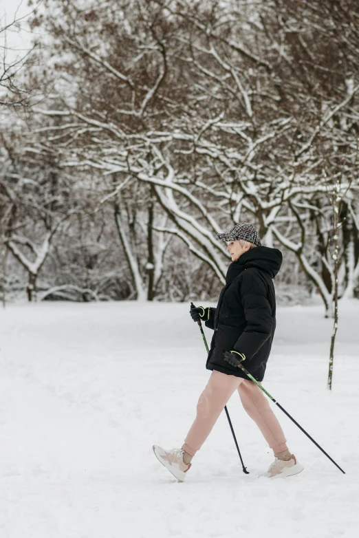 a woman cross country skiing in the snow, trending on unsplash, walking at the park, avatar image, thumbnail, grey