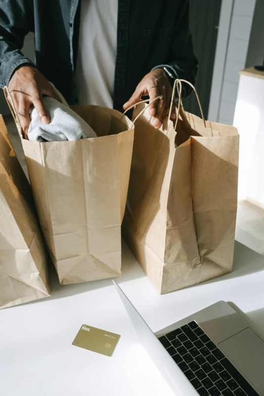 a man holding shopping bags in front of a laptop, by Everett Warner, pexels contest winner, renaissance, instagram story, brown paper, people inside eating meals, upon a peak in darien