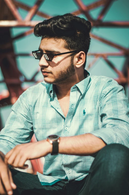 a man sitting on top of a wooden bench, by Max Dauthendey, pexels contest winner, hurufiyya, wearing a light blue shirt, with sunglass, profile pic, avatar image