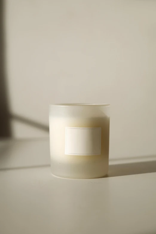 a candle that is sitting on a table, light grey mist, straight camera view, translucent white skin, light frame