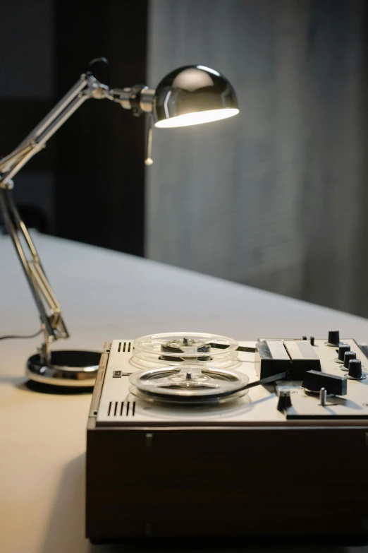 a record player sitting on top of a table next to a lamp, kinetic art, close up shot from the side, museum archive, tape deck, courtesy of centre pompidou