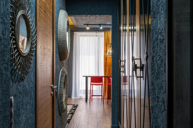 a hallway with blue walls and a red chair, by Adam Marczyński, pexels contest winner, nesting glass doors, apartment with black walls, concept eclectic, neo kyiv