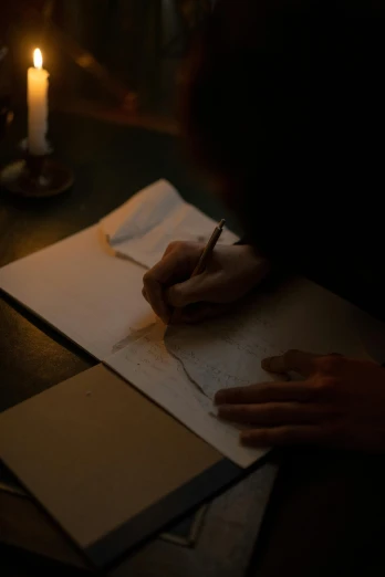 a person writing on a piece of paper with a candle in the background, by Daniel Seghers, process art, atmospheric cinematography, historical setting, promo image, charts