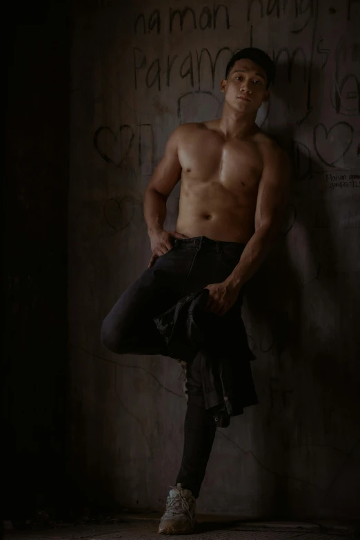 a shirtless man leaning against a wall, a picture, inspired by Carlo Mense, damon salvatore, kevin hou, grungy, gif