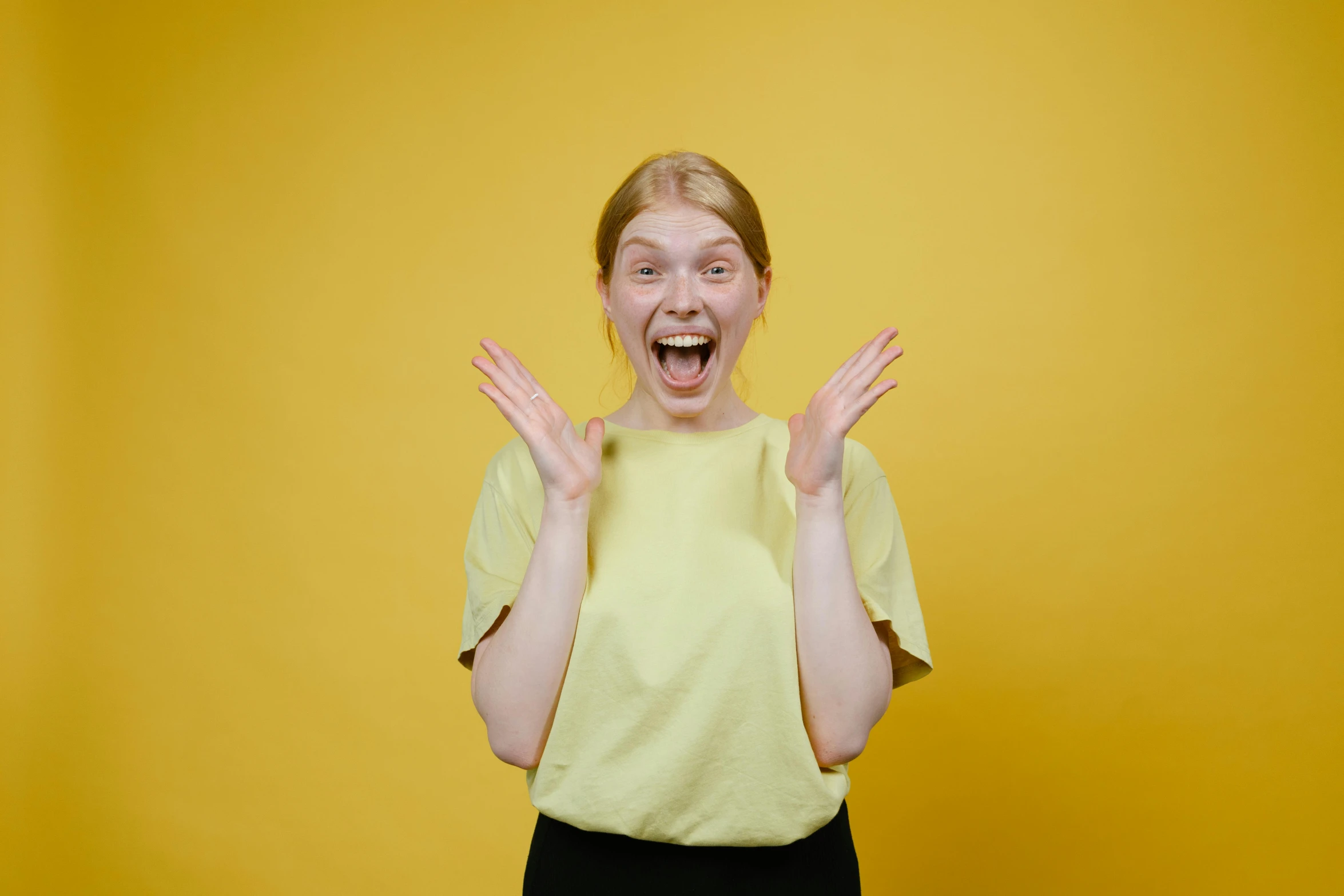 a woman making a funny face with her hands, pexels contest winner, all overly excited, avatar image, yellow skin, 15081959 21121991 01012000 4k