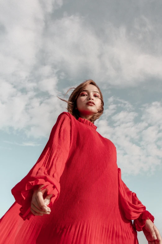 a woman in a red dress standing in a field, inspired by Viktor de Jeney, trending on pexels, standing on rooftop, voluminous sleeves, official store photo, promotional image