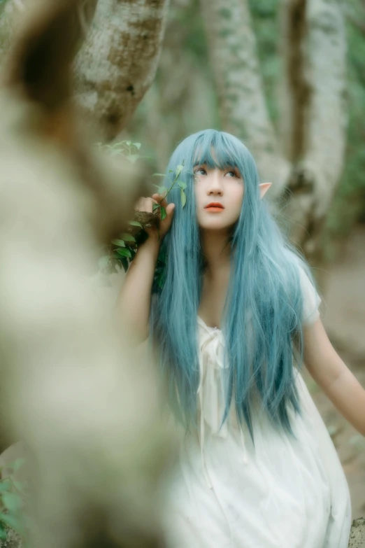 a woman with blue hair walking through a forest, an album cover, unsplash, cover photo portrait of du juan, an elf, ((forest))