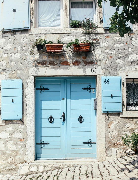 a blue door in front of a stone building, pexels contest winner, cyan shutters on windows, thumbnail, multiple stories, croatian coastline