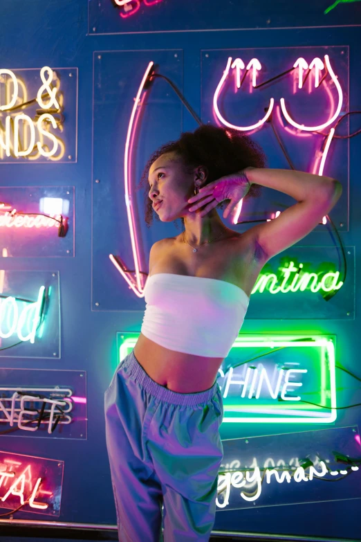 a woman standing in front of neon signs, trending on pexels, interactive art, wearing crop top, bisexual lighting, ashteroth, portrait sophie mudd