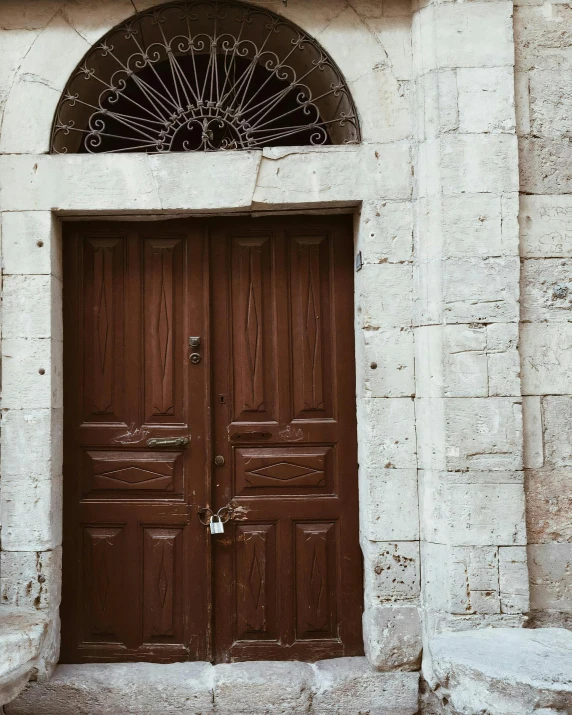 a red fire hydrant sitting in front of a wooden door, by Kristian Zahrtmann, pexels contest winner, romanesque, damascus, brown color palette, white marble interior photograph, lgbtq