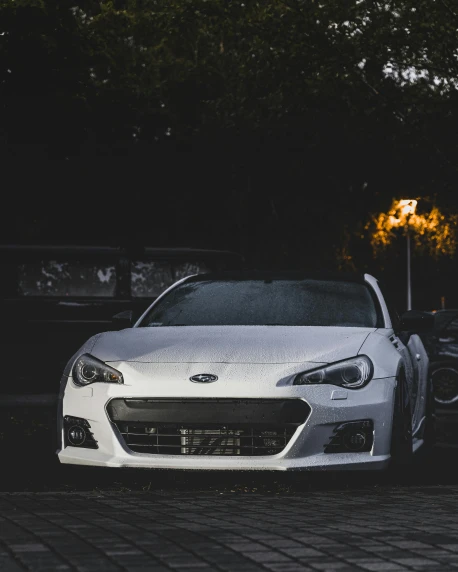 a white sports car parked in a parking lot, by Adam Marczyński, pexels contest winner, subaru, square, front flash, low quality photo