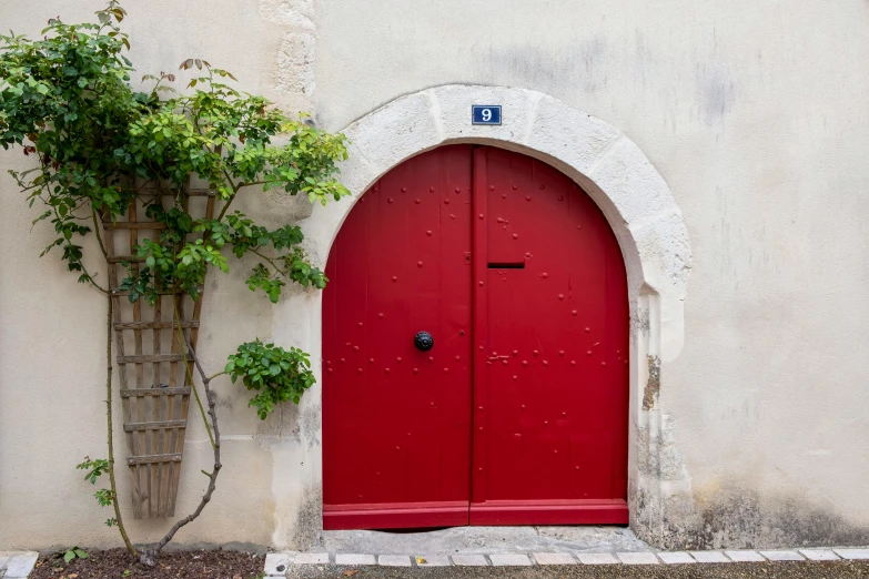 a red door that is on the side of a building, les nabis, an archway, eight eight eight, contrejour, crimson
