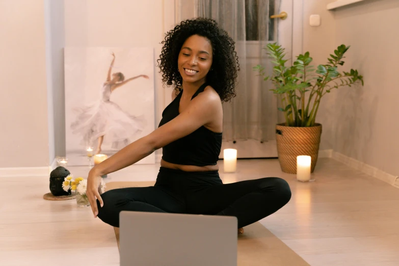 a woman sitting on the floor with a laptop, trending on pexels, happening, dance meditation, avatar image, with a ponytail, smiling at camera