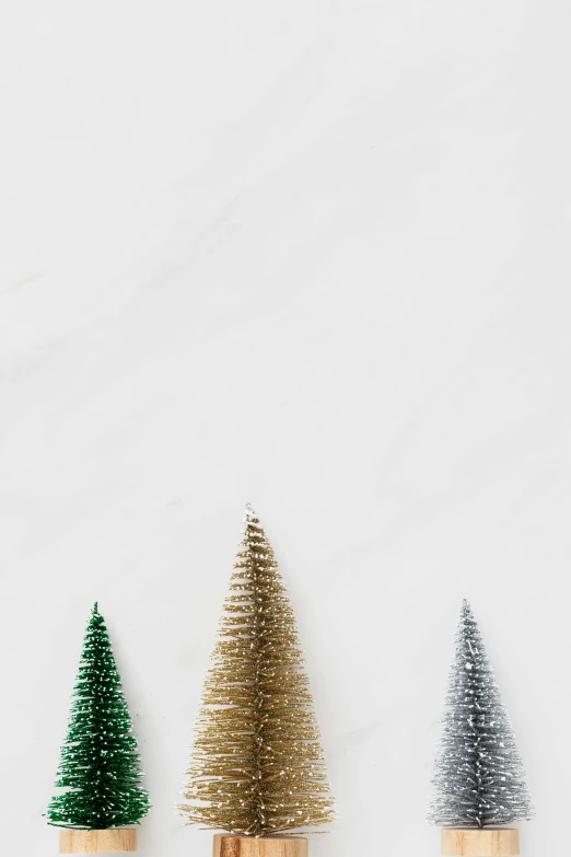 a group of christmas trees sitting next to each other, trending on unsplash, minimalism, glitter gif, - 9, dwell, high resolution product photo