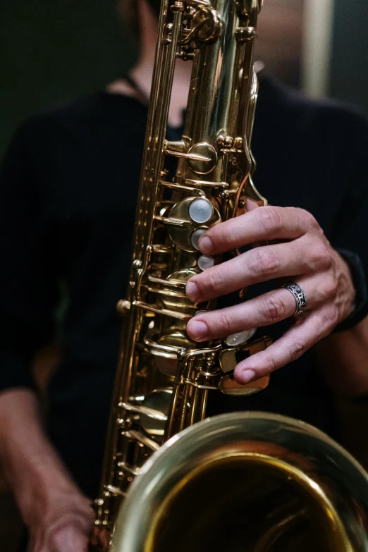 a close up of a person holding a saxophone, pexels contest winner, gold layers, australian, instagram post, 15081959 21121991 01012000 4k