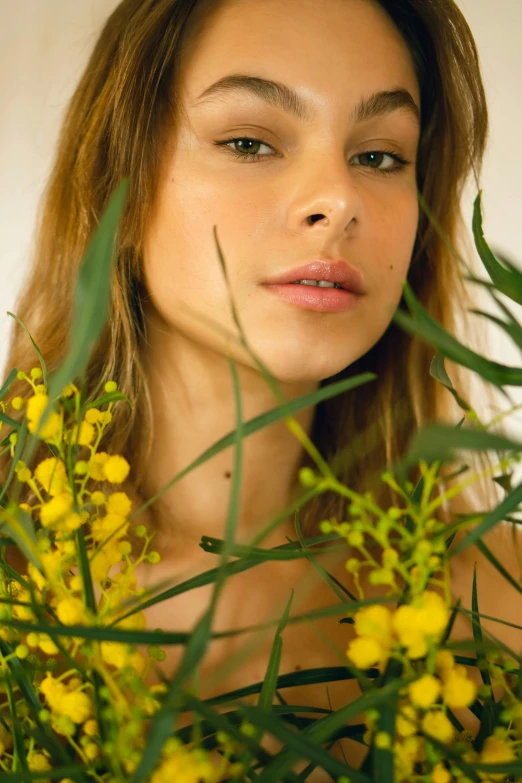 a woman holding a bouquet of yellow flowers, trending on pexels, fine art, portrait of barbara palvin, woman made of plants, manuka, tanned beauty portrait