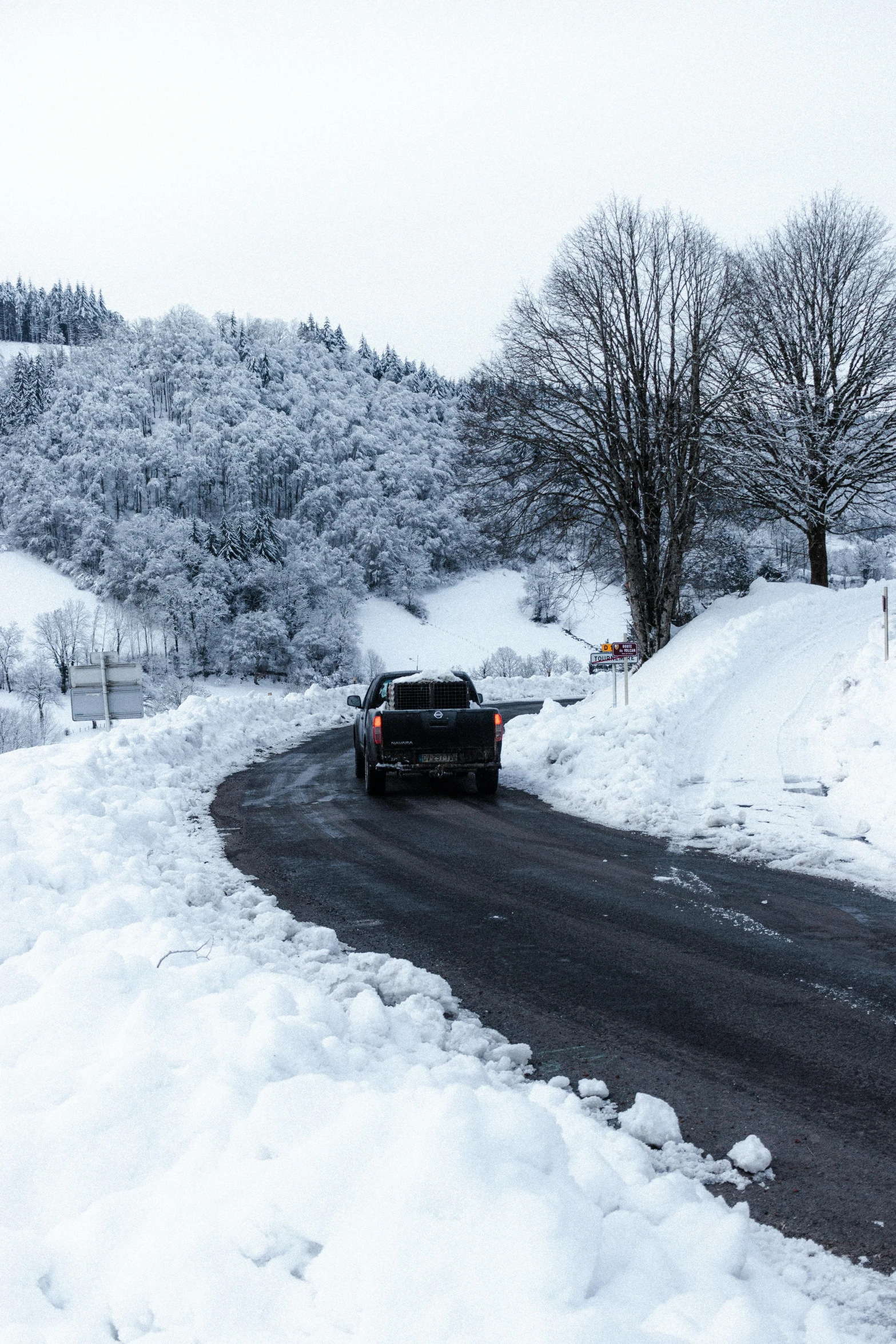 a car driving down a snow covered road, les nabis, paved roads, thumbnail, black forest, contain