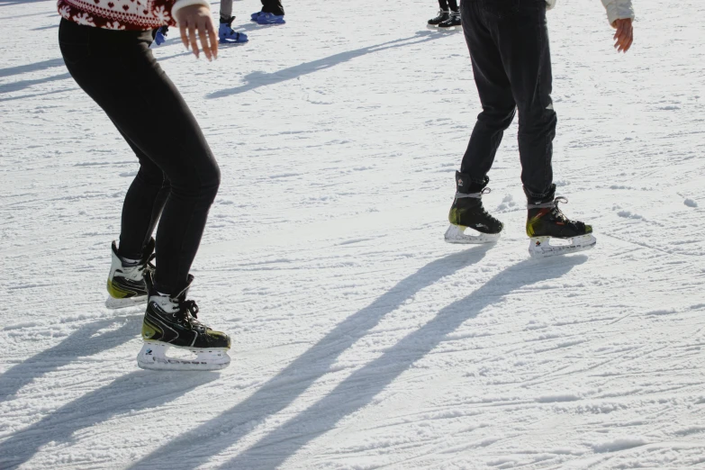 a group of people riding skis on top of a snow covered slope, roller skating, up close image, knobbly knees, subtle detailing