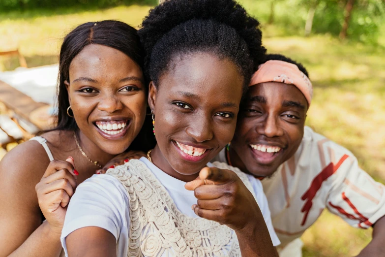 a group of women standing next to each other, a picture, by Chinwe Chukwuogo-Roy, pexels contest winner, brown skin man with a giant grin, selfie of a young woman, portrait of family of three, promotional image