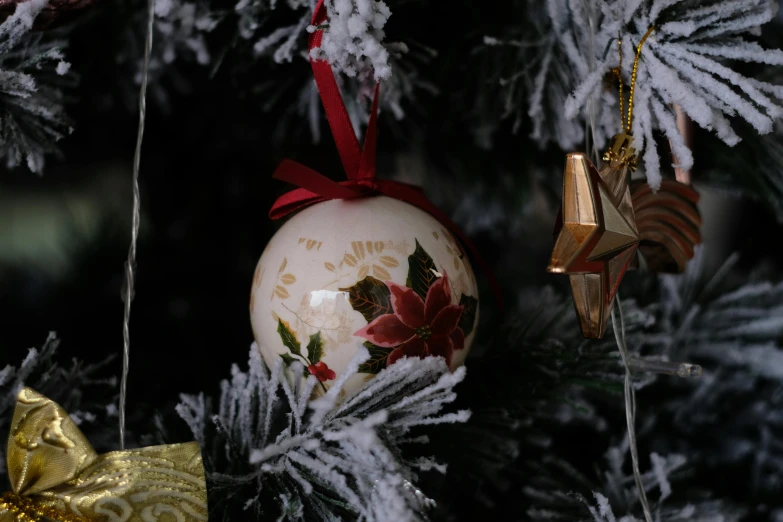 a close up of a christmas ornament on a tree, pexels, arabesque, ceramic, square, ivory, hand painted