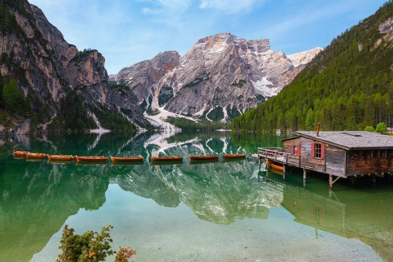 a boat dock in the middle of a lake with mountains in the background, by Bernardino Mei, pexels contest winner, lago di sorapis, slim aarons, gondolas, forest with lake