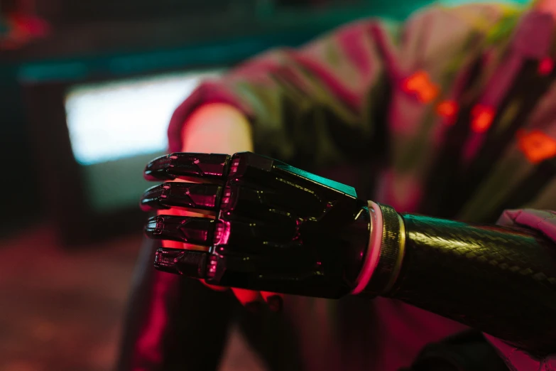 a close up of a glove on a person's arm, cyberpunk art, unsplash, robotic limbs on floor, mechanical features and neon, wearing cyberpunk leather jacket, humanoid servo