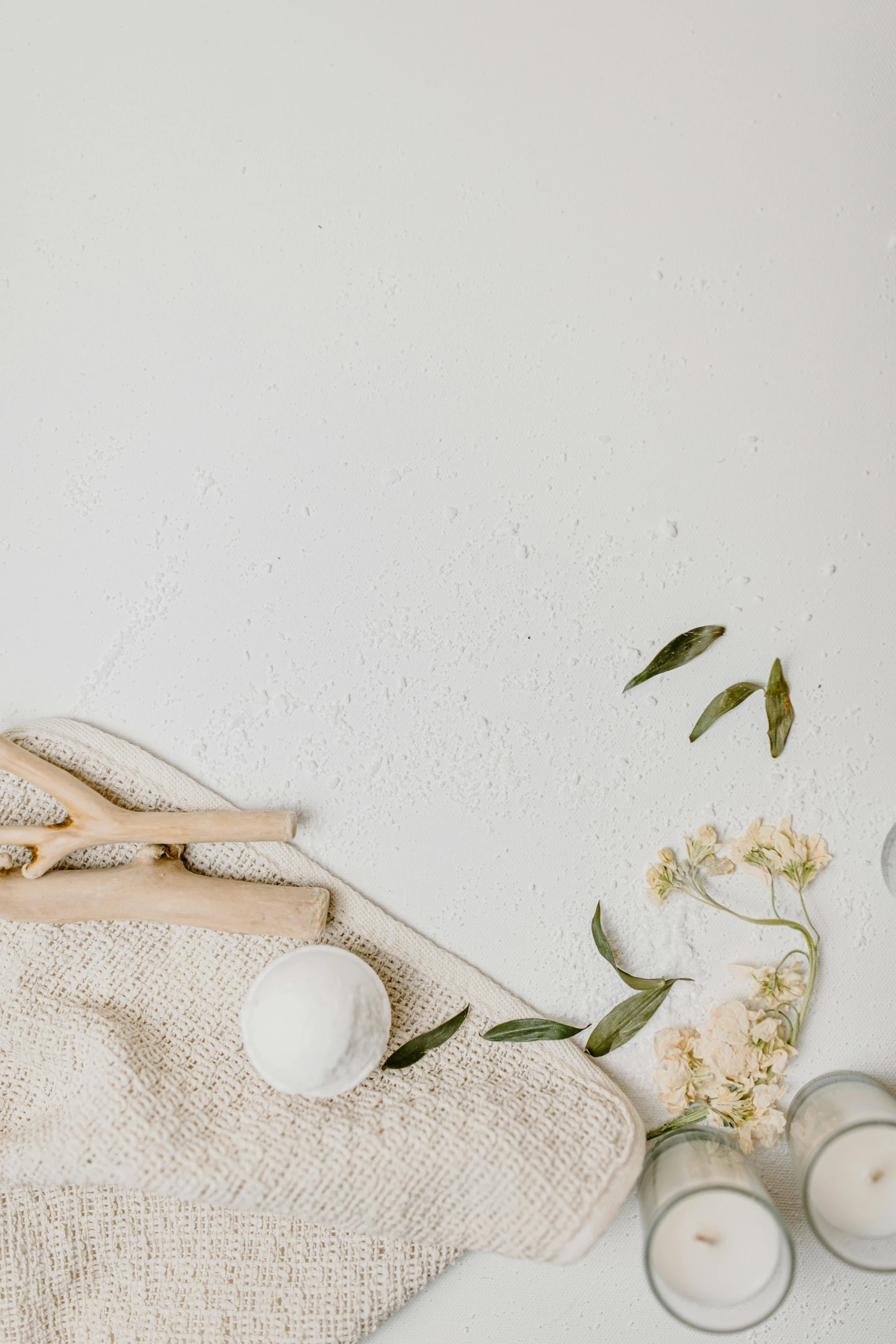 a wooden spoon sitting on top of a table next to candles, a still life, trending on unsplash, minimalism, carved soap, made of flowers and leaves, white canvas background, bubble bath