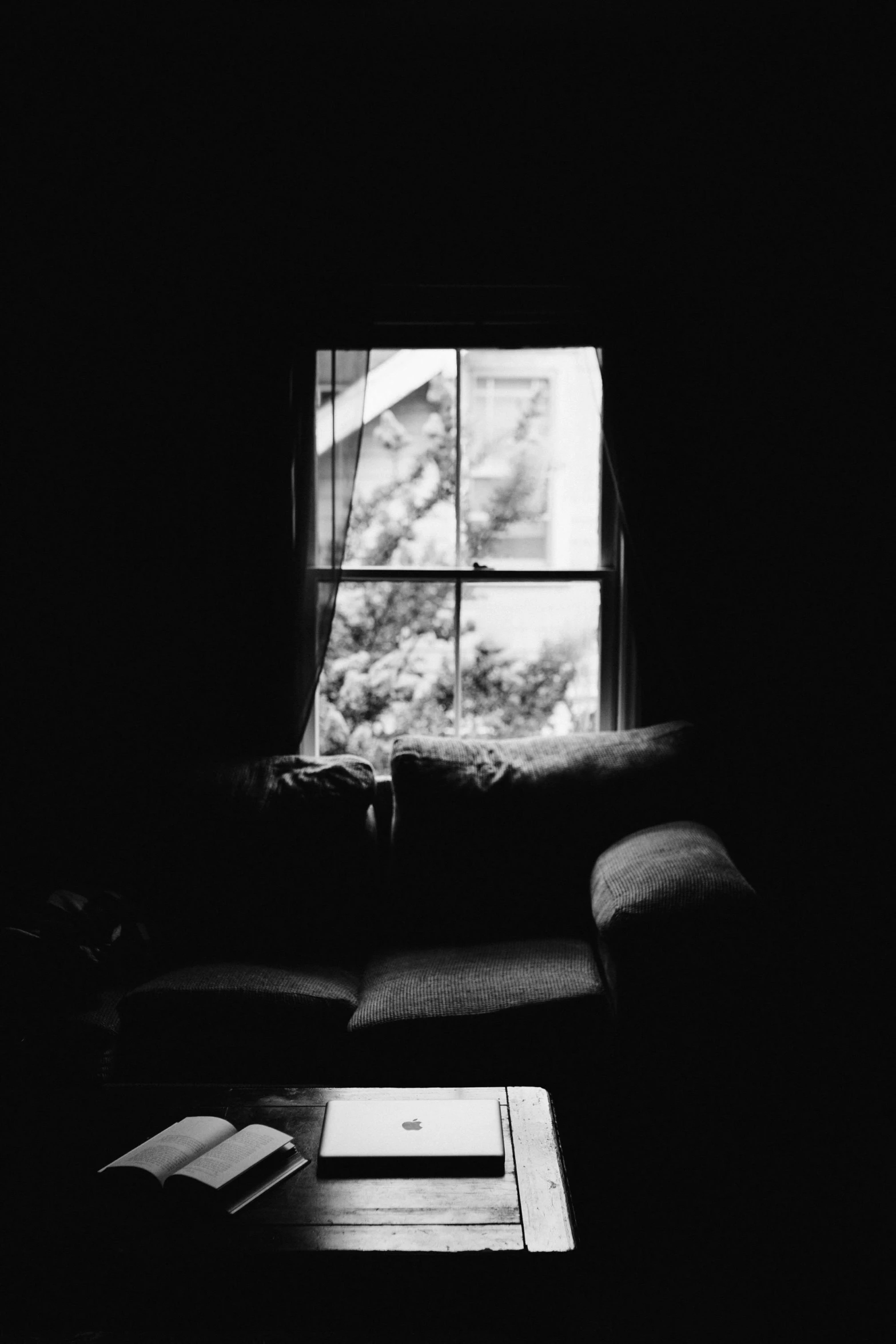 a black and white photo of a living room, a black and white photo, unsplash, conceptual art, window to night time, medium format. soft light, sittin, analogue photo