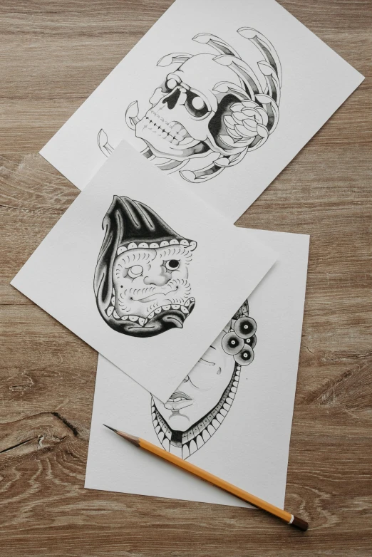 a couple of cards sitting on top of a wooden table, an ink drawing, featured on behance, three heads, portrait of a sugar skull, coloring pages, fine art print