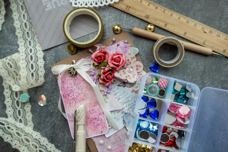 a bunch of craft supplies sitting on top of a table, by Sylvia Wishart, pexels contest winner, delicate embellishments, ribbon, architect, 9 9 designs