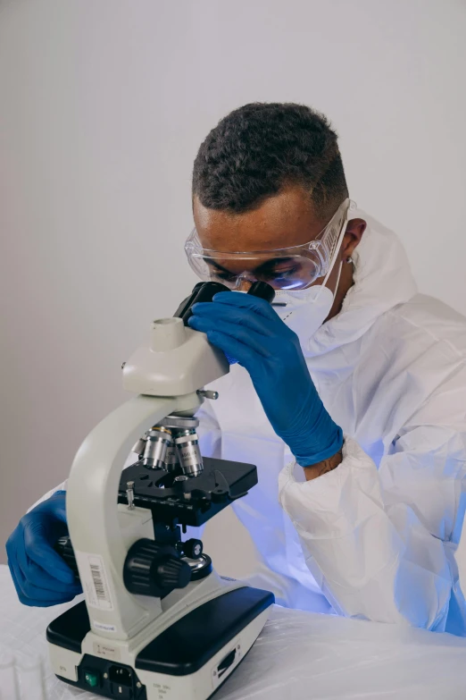 a man in a lab coat looking through a microscope, pexels, wearing gloves, gif, ashteroth, profile picture