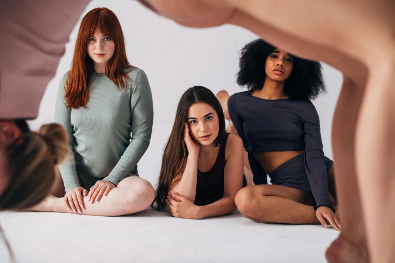 a group of women sitting on top of a white floor, inspired by Vanessa Beecroft, trending on pexels, renaissance, ( redhead, wearing a cute top, grey, coloured