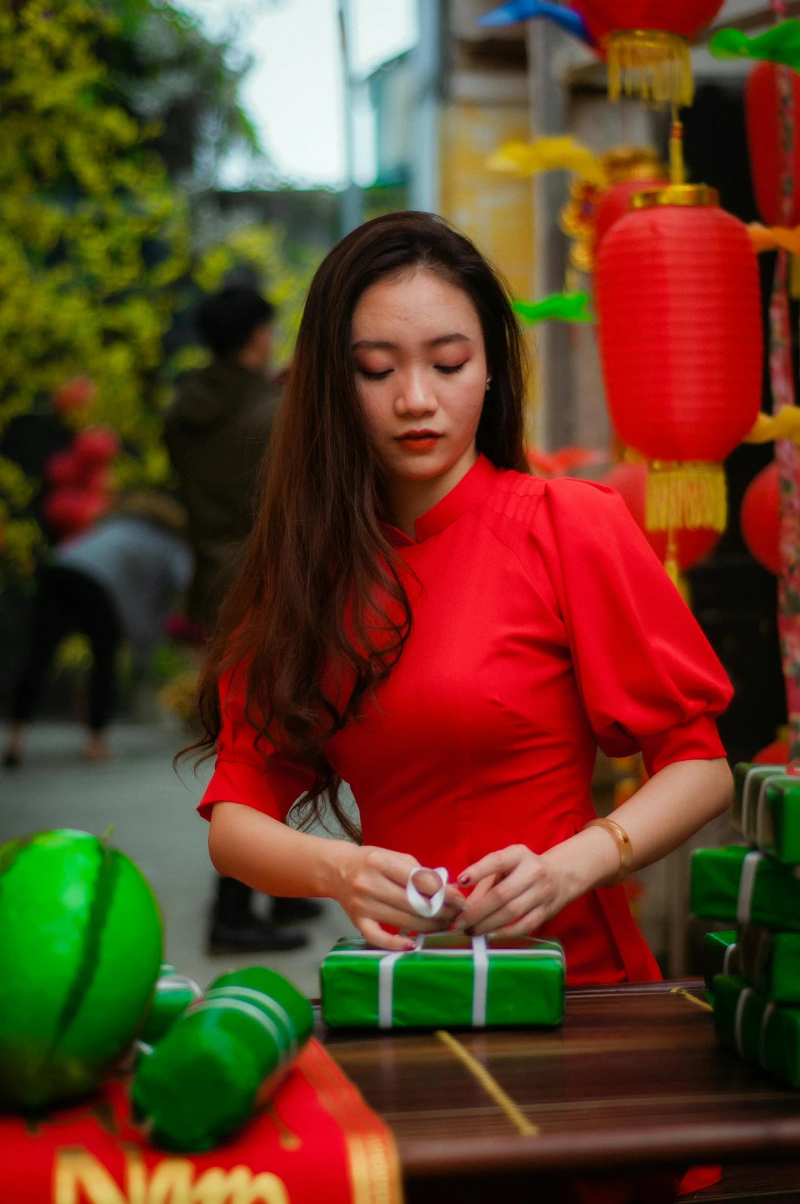 a woman in a red dress putting presents on a table, pexels contest winner, vietnamese temple scene, red green, avatar image, handsome girl