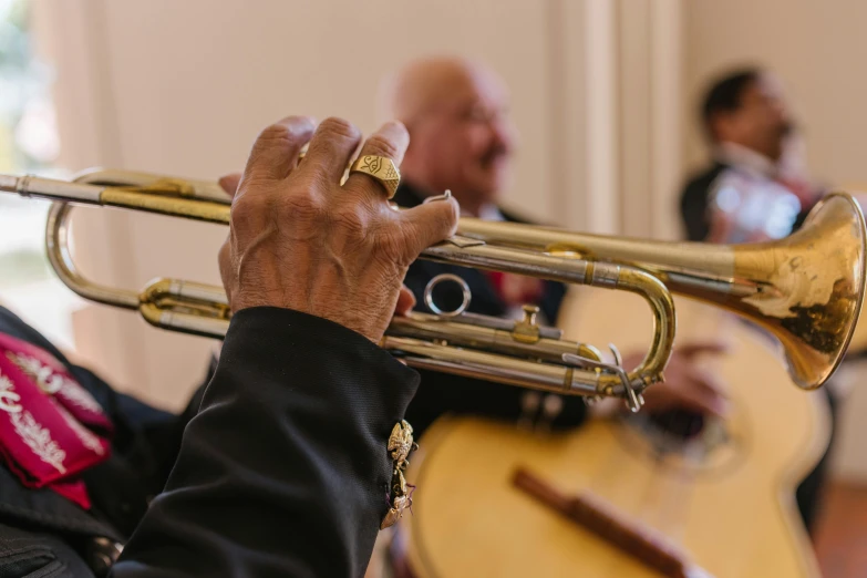 a close up of a person playing a trumpet, camaraderie, inside a grand, 70 years old, profile image