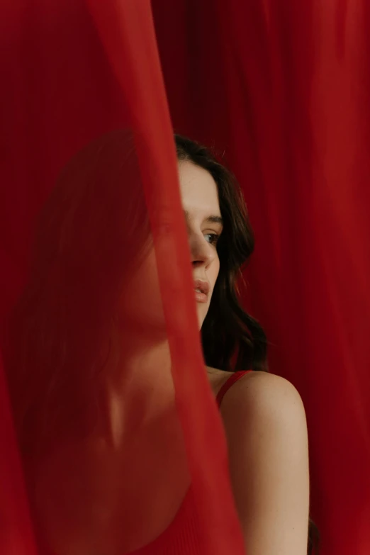 a woman standing in front of a red curtain, pale skin, red fabric, iu, fernanda suarez