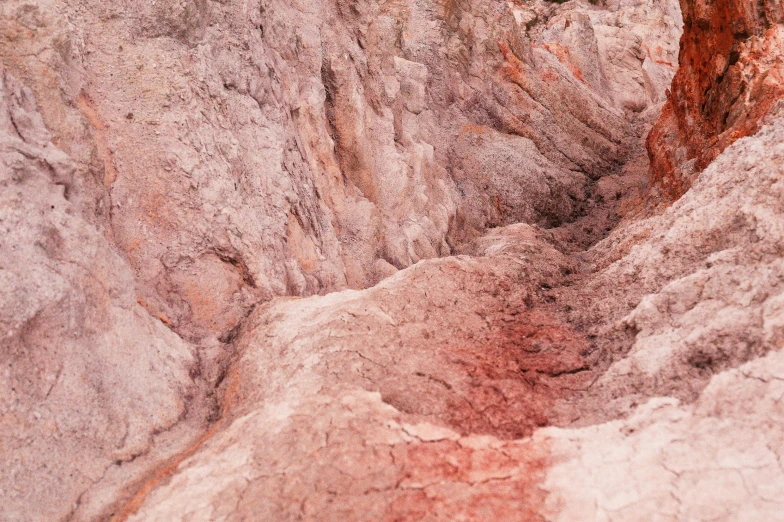 a red fire hydrant sitting in the middle of a canyon, an album cover, inspired by William Congdon, unsplash contest winner, australian tonalism, pink concrete, geological strata, digging, geode